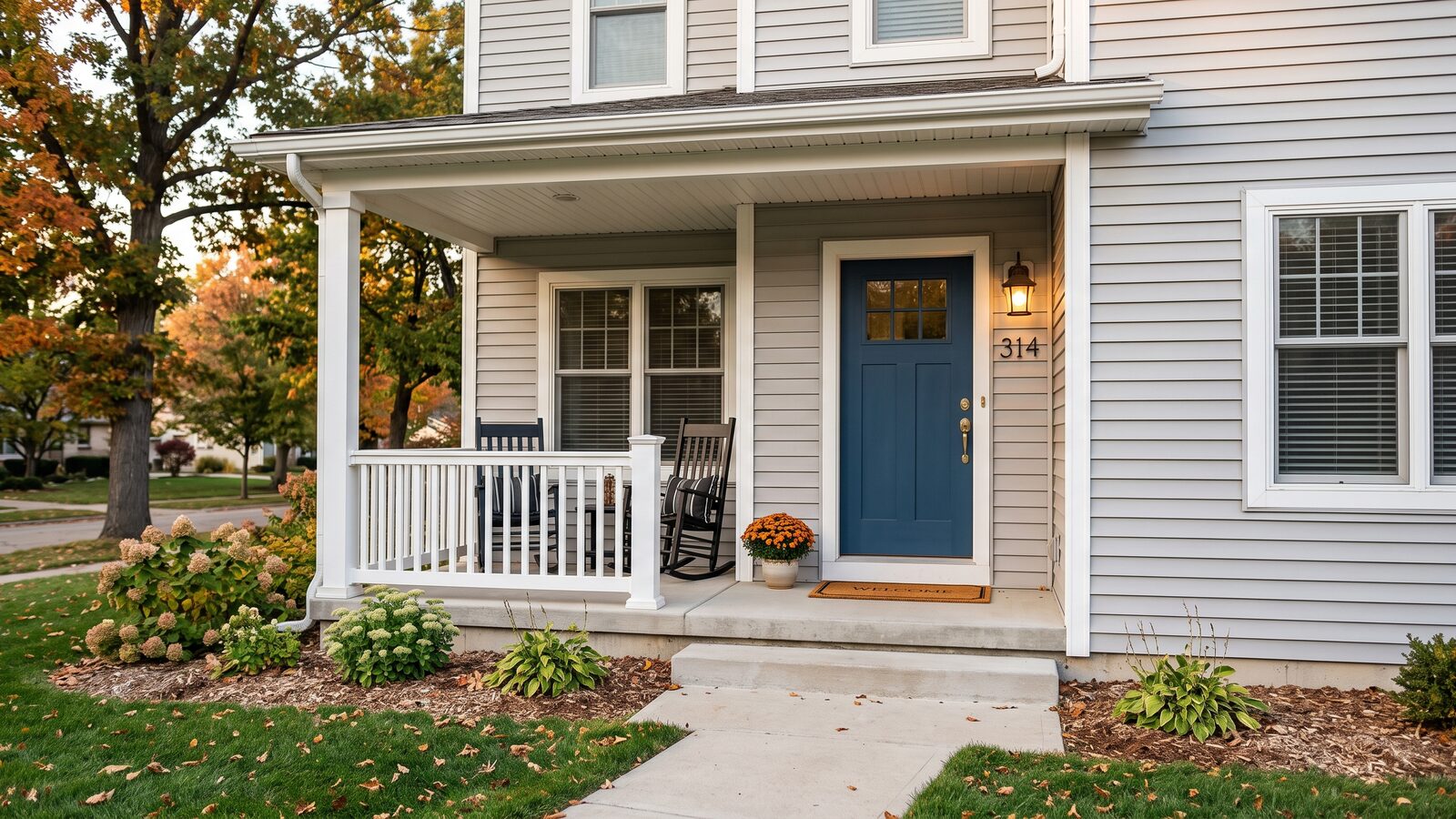 The front entry of a Midwest home with vinyl siding visible on the facade